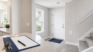 Clean Connecticut rental unit entryway with a property manager checklist, keys, smoke detector, outlet, and inspection-readiness details.
